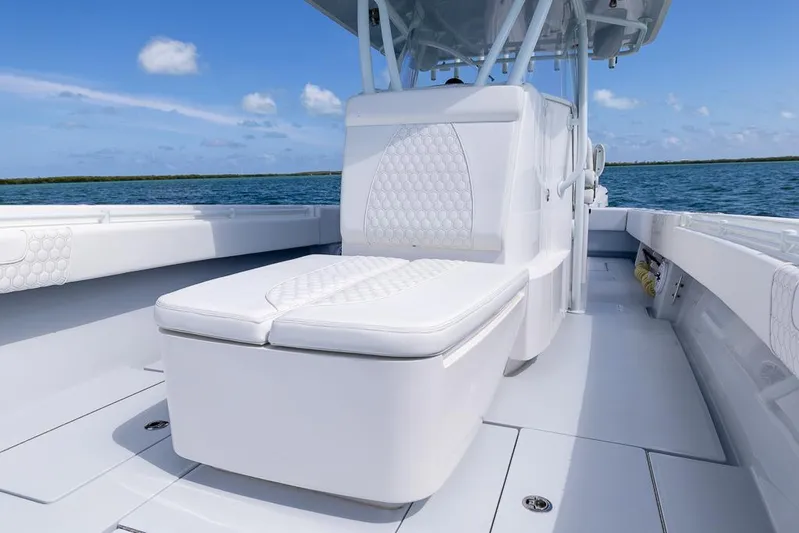  Yacht Photos Pics 2023 Contender 39 ST boat interior with white seating, ocean backdrop.