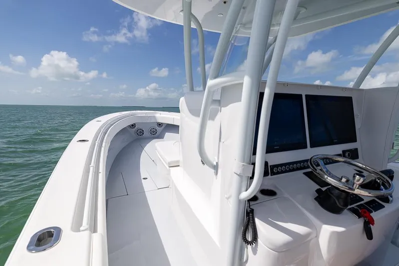  Yacht Photos Pics 2023 Contender 39 ST boat helm with dual screens on open water.