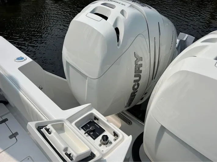  Yacht Photos Pics 2002 Intrepid 348 WA boat with Mercury outboard engines on water.