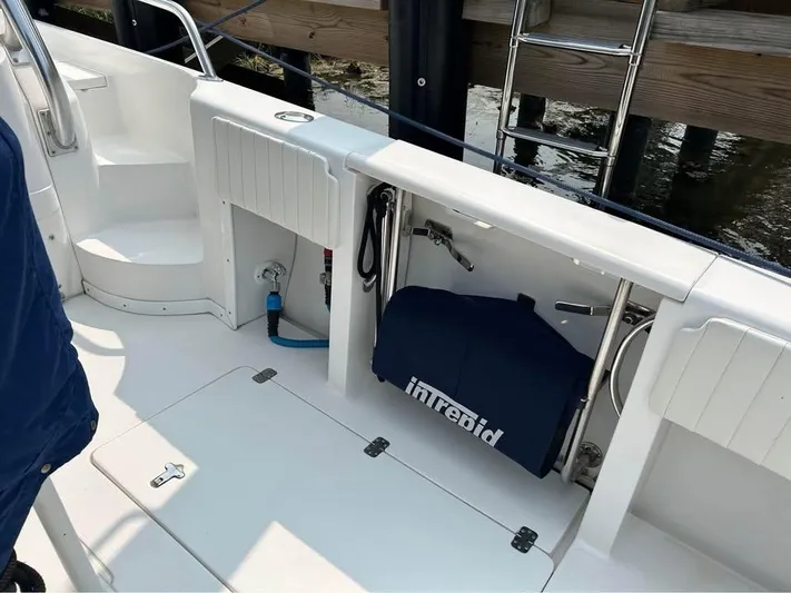  Yacht Photos Pics 2002 Intrepid 348 WA boat interior with storage compartments and ladder.