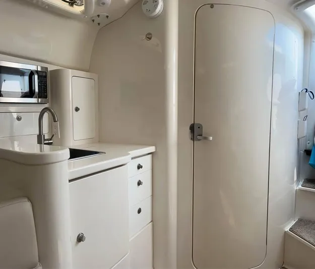  Yacht Photos Pics 2002 Intrepid 348 WA boat interior with kitchenette and storage cabinets.