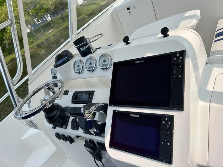  Yacht Photos Pics 2002 Intrepid 348 WA boat dashboard with dual Simrad displays and steering wheel.