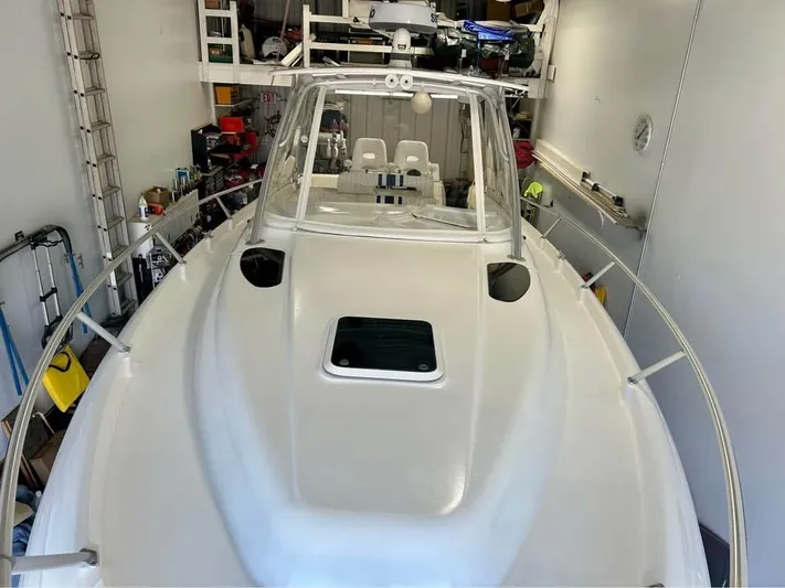  Yacht Photos Pics 2002 Intrepid 348 WA boat in a garage, showcasing its sleek design and spacious deck.