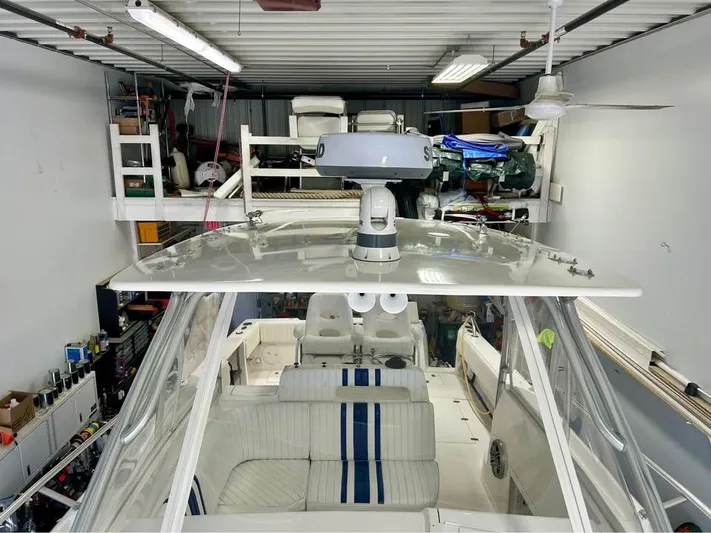  Yacht Photos Pics 2002 Intrepid 348 WA boat in storage, featuring white and blue seating.