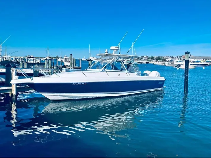  Yacht Photos Pics 2002 Intrepid 348 WA boat docked in a marina under clear blue skies.