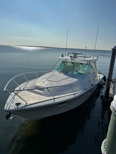 Still Wreckless Yacht Photos Pics 2014 SeaVee 430 SE boat docked on calm water under clear sky.