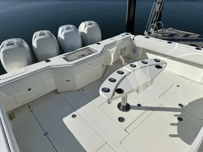 Still Wreckless Yacht Photos Pics 2014 SeaVee 430 SE boat deck with multiple outboard engines and rod holders.