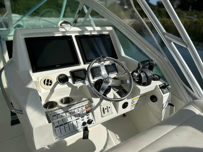 Still Wreckless Yacht Photos Pics Helm of 2014 SeaVee 430 SE boat with dual screens and controls.