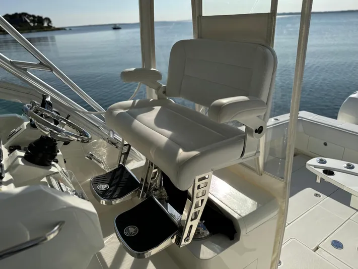 Still Wreckless Yacht Photos Pics Captain's chair on 2014 SeaVee 430 SE boat, overlooking calm waters.