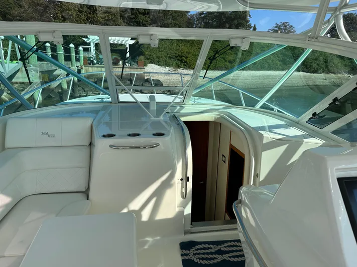 Still Wreckless Yacht Photos Pics 2014 SeaVee 430 SE boat interior with white seating and glass windows.