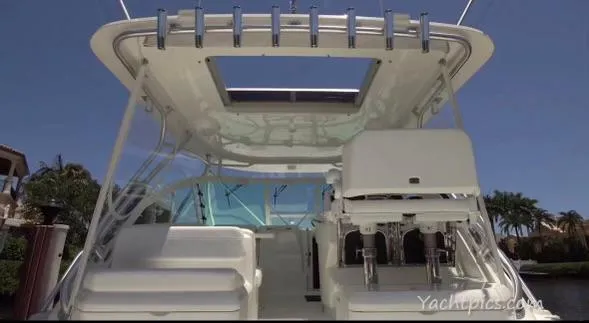 Still Wreckless Yacht Photos Pics 2014 SeaVee 430 SE boat interior with seating and rod holders under a clear blue sky.