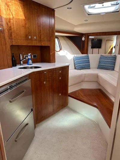 Still Wreckless Yacht Photos Pics Luxurious interior of 2014 SeaVee 430 SE yacht with kitchenette and seating area.