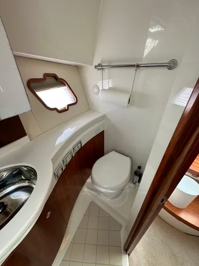 Still Wreckless Yacht Photos Pics 2014 SeaVee 430 SE yacht bathroom with toilet, sink, and porthole window.