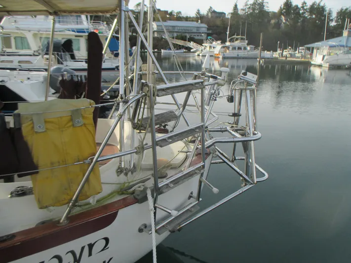  Yacht Photos Pics Sailboat docked in marina, Pacific Seacraft 37, 1990 model, with metal framework and equipment.