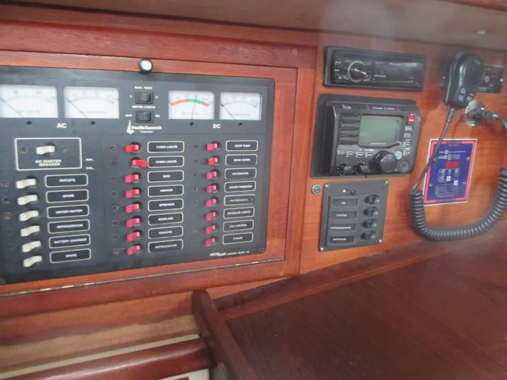  Yacht Photos Pics Electrical control panel on a 1990 Pacific Seacraft 37 sailboat, featuring gauges and communication equipment.