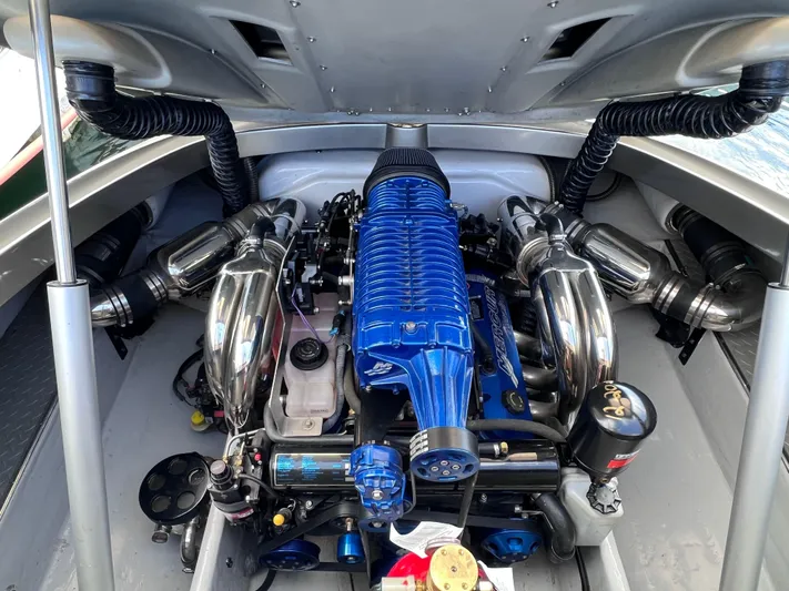 Unique Yacht Photos Pics Engine of a 2008 Porsche/Donzi boat, featuring a blue supercharger and chrome components.