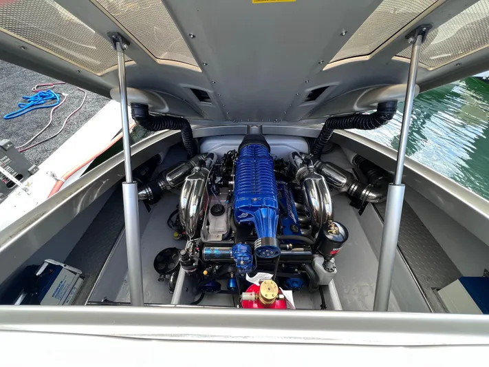 Unique Yacht Photos Pics Engine compartment of a 2008 Porsche/Donzi boat, featuring a powerful blue engine.