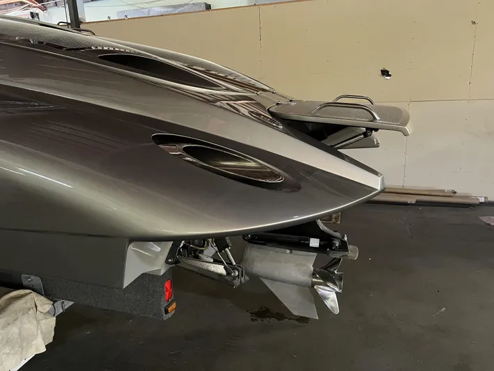 Unique Yacht Photos Pics 2008 Porsche Donzi boat, sleek design, metallic finish, rear view in a garage setting.