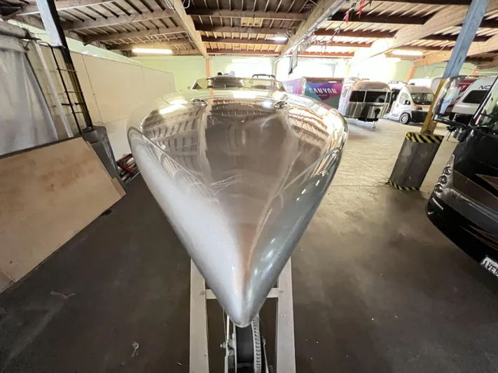 Unique Yacht Photos Pics 2008 Porsche Donzi boat in a warehouse, showcasing sleek design and metallic finish.