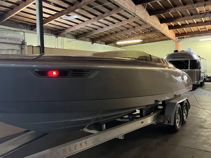 Unique Yacht Photos Pics 2008 Porsche Donzi boat on trailer in a wooden-ceiling garage.