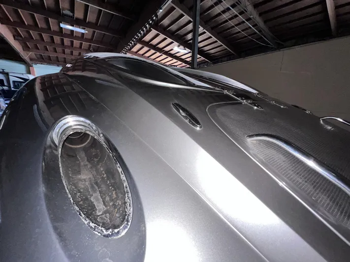 Unique Yacht Photos Pics 2008 Porsche Donzi boat in a garage, showcasing sleek metallic design and circular window.