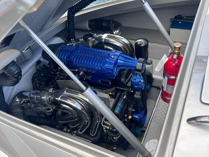 Unique Yacht Photos Pics 2008 Porsche Donzi engine with blue components and fire extinguisher in open compartment.