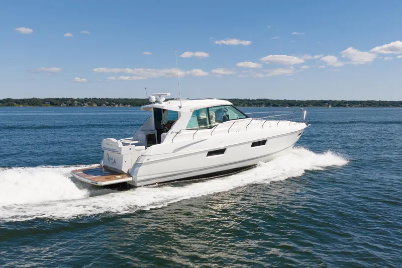 Epic Yacht Photos Pics 2013 Cruisers Yachts 48 Cantius cruising on open water under a clear blue sky.