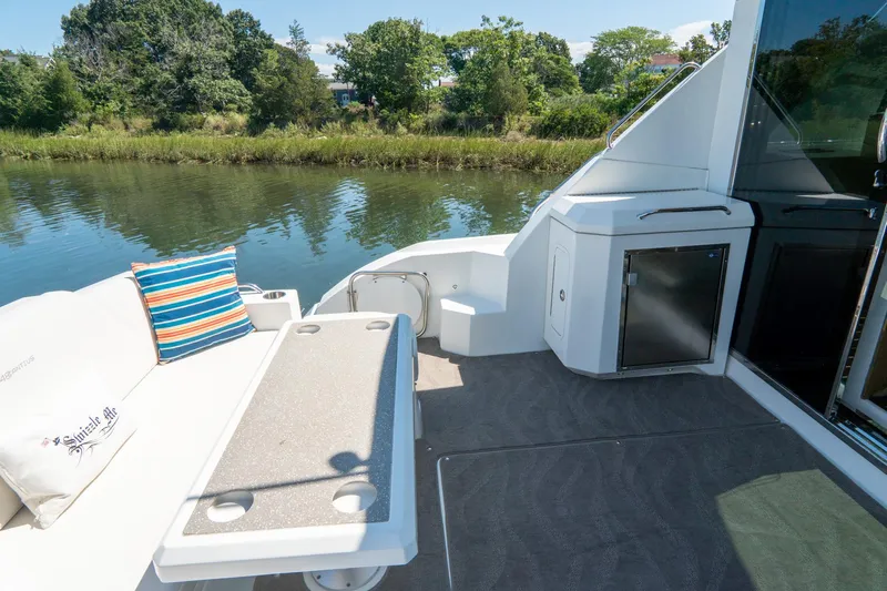 Epic Yacht Photos Pics 2013 Cruisers Yachts 48 Cantius deck with seating, table, and scenic water view.