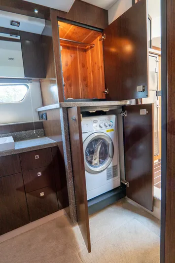 Epic Yacht Photos Pics 2013 Cruisers Yachts 48 Cantius interior with built-in washer in wooden cabinet.