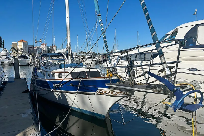 Makani Yacht Photos Pics Sailboat Gozzard 44 MK1 AC, 1993 model, docked in a marina under clear blue skies.