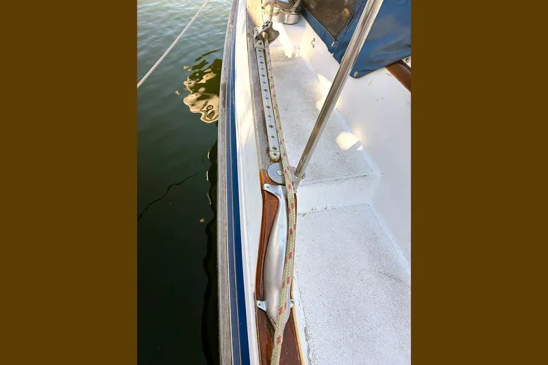 Makani Yacht Photos Pics Deck view of 1993 Gozzard 44 MK1 AC sailboat, showing railing and water reflection.