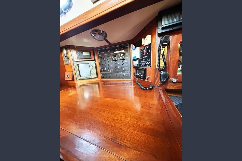 Makani Yacht Photos Pics Navigation station of 1993 Gozzard 44 MK1 AC yacht with control panels and communication equipment.