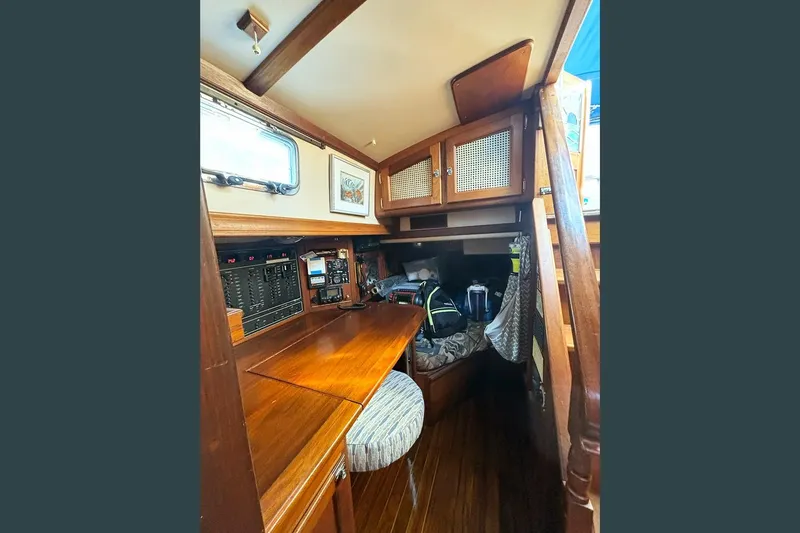 Makani Yacht Photos Pics Interior of 1993 Gozzard 44 MK1 AC sailboat with wooden cabinetry and navigation equipment.