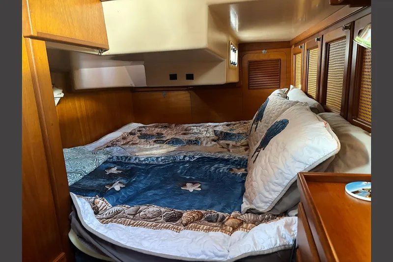 Makani Yacht Photos Pics Cozy cabin interior of 1993 Gozzard 44 MK1 AC with nautical-themed bedding.