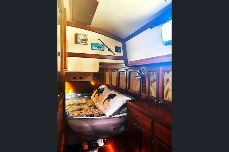 Makani Yacht Photos Pics Cozy cabin interior of 1993 Gozzard 44 MK1 AC sailboat with wooden furnishings.