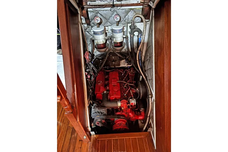 Makani Yacht Photos Pics Engine compartment of 1993 Gozzard 44 MK1 AC sailboat, featuring red engine and gauges.