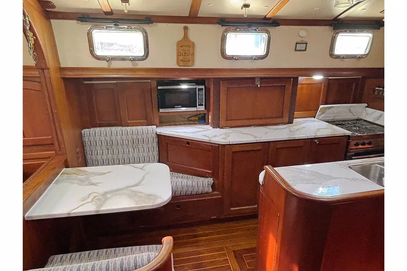 Makani Yacht Photos Pics Interior of 1993 Gozzard 44 MK1 AC yacht with wood cabinetry and marble countertops.