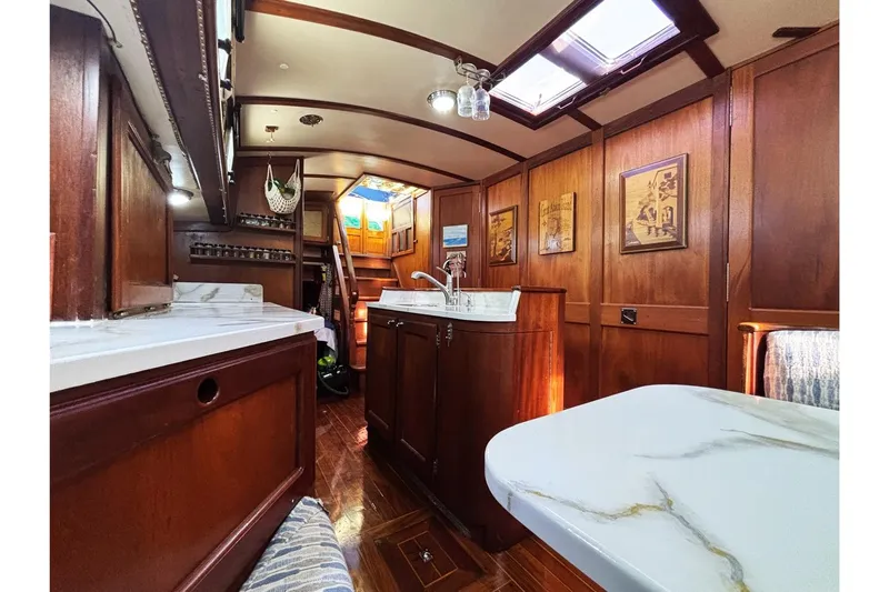 Makani Yacht Photos Pics Luxurious 1993 Gozzard 44 MK1 AC yacht interior with elegant wood paneling and marble countertops.