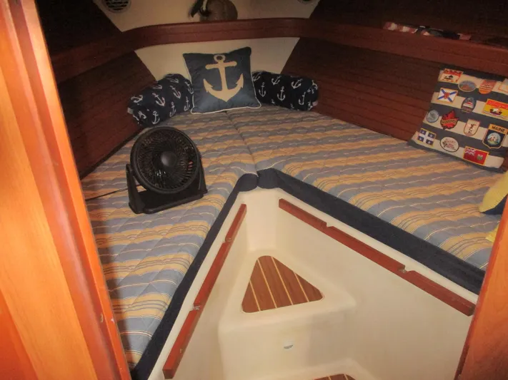  Yacht Photos Pics Cozy cabin interior of 2007 Mainship Pilot 34 Sedan with nautical-themed decor.