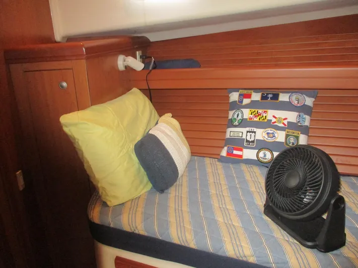  Yacht Photos Pics Cozy cabin interior of 2007 Mainship Pilot 34 Sedan with cushions and fan.