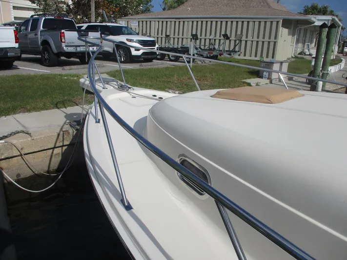  Yacht Photos Pics 2007 Mainship Pilot 34 Sedan docked, showcasing sleek design and sturdy railings.