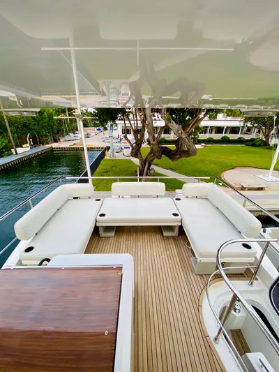 Ivy Therapy Yacht Photos Pics 2015 Azimut 50 yacht deck with white seating and wooden flooring.