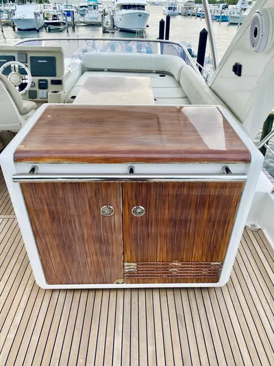 Ivy Therapy Yacht Photos Pics Wooden cabinet on 2015 Azimut 50 yacht deck, with marina view.