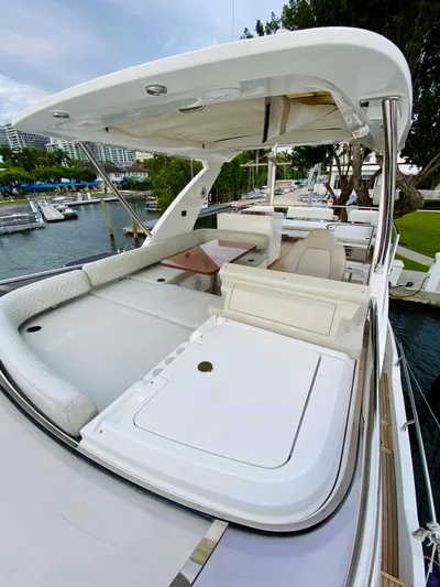 Ivy Therapy Yacht Photos Pics 2015 Azimut 50 yacht with spacious deck and seating area, docked by the water.