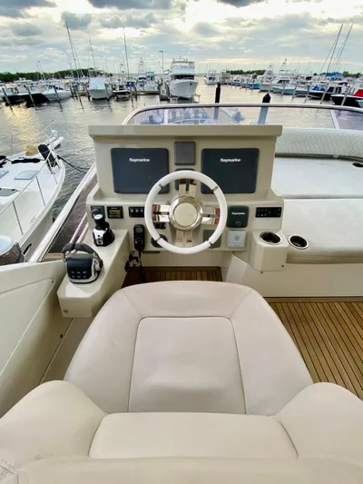 Ivy Therapy Yacht Photos Pics Azimut 50 yacht helm, 2015 model, with dual Raymarine displays in a marina setting.