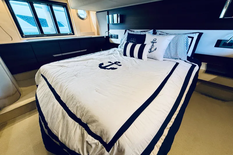 Ivy Therapy Yacht Photos Pics Luxurious bedroom interior of 2015 Azimut 50 yacht with nautical-themed bedding.