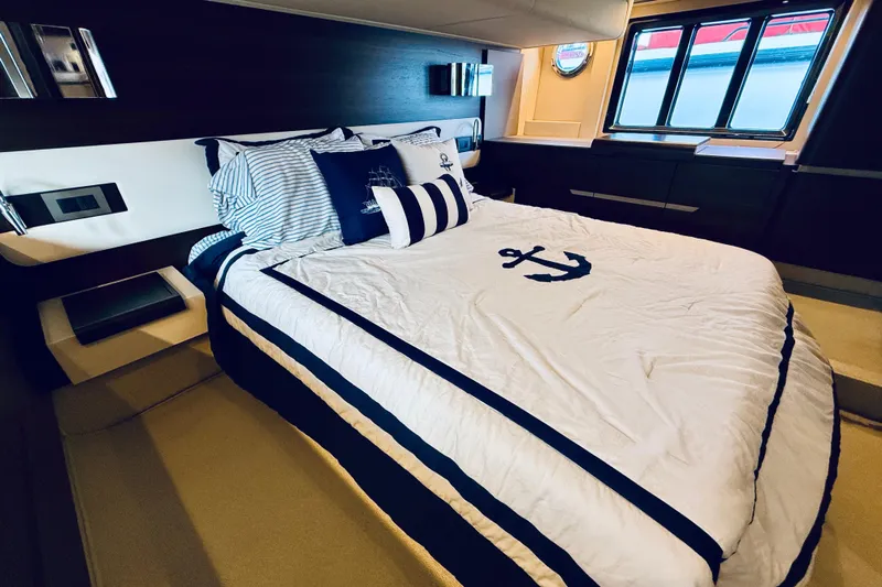 Ivy Therapy Yacht Photos Pics Luxurious bedroom interior of 2015 Azimut 50 yacht with nautical-themed bedding.