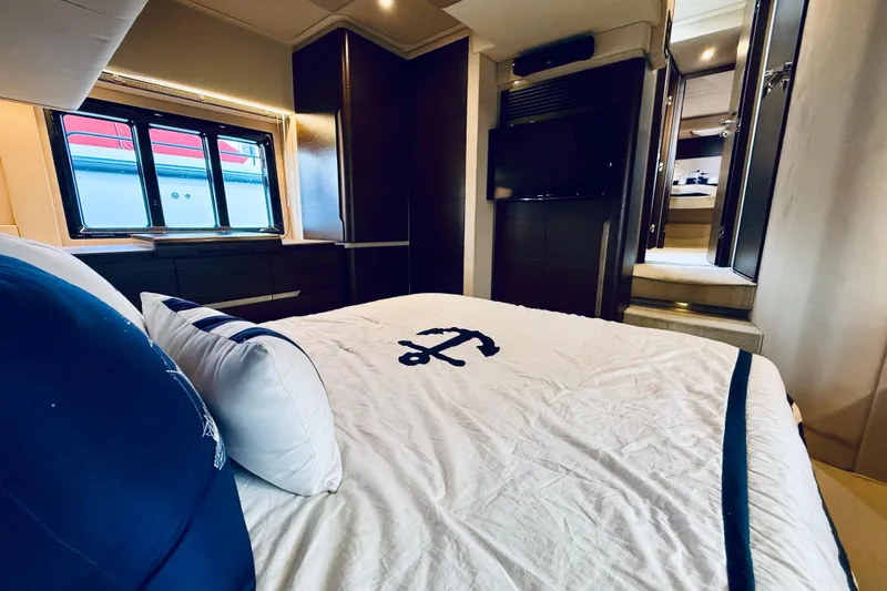 Ivy Therapy Yacht Photos Pics Luxurious bedroom interior of 2015 Azimut 50 yacht with nautical-themed bedding.