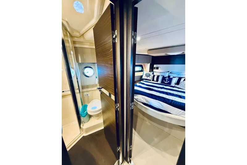 Ivy Therapy Yacht Photos Pics Luxurious 2015 Azimut 50 yacht interior with nautical-themed bedroom and compact bathroom.