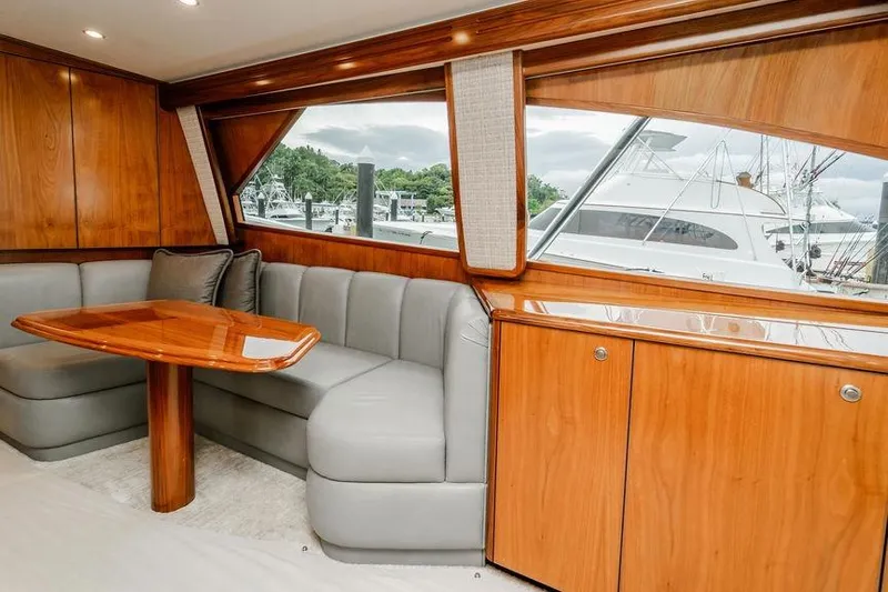 Trailer Trash Yacht Photos Pics Luxurious interior of 2021 Viking 58 Convertible yacht with wood finish and plush seating.